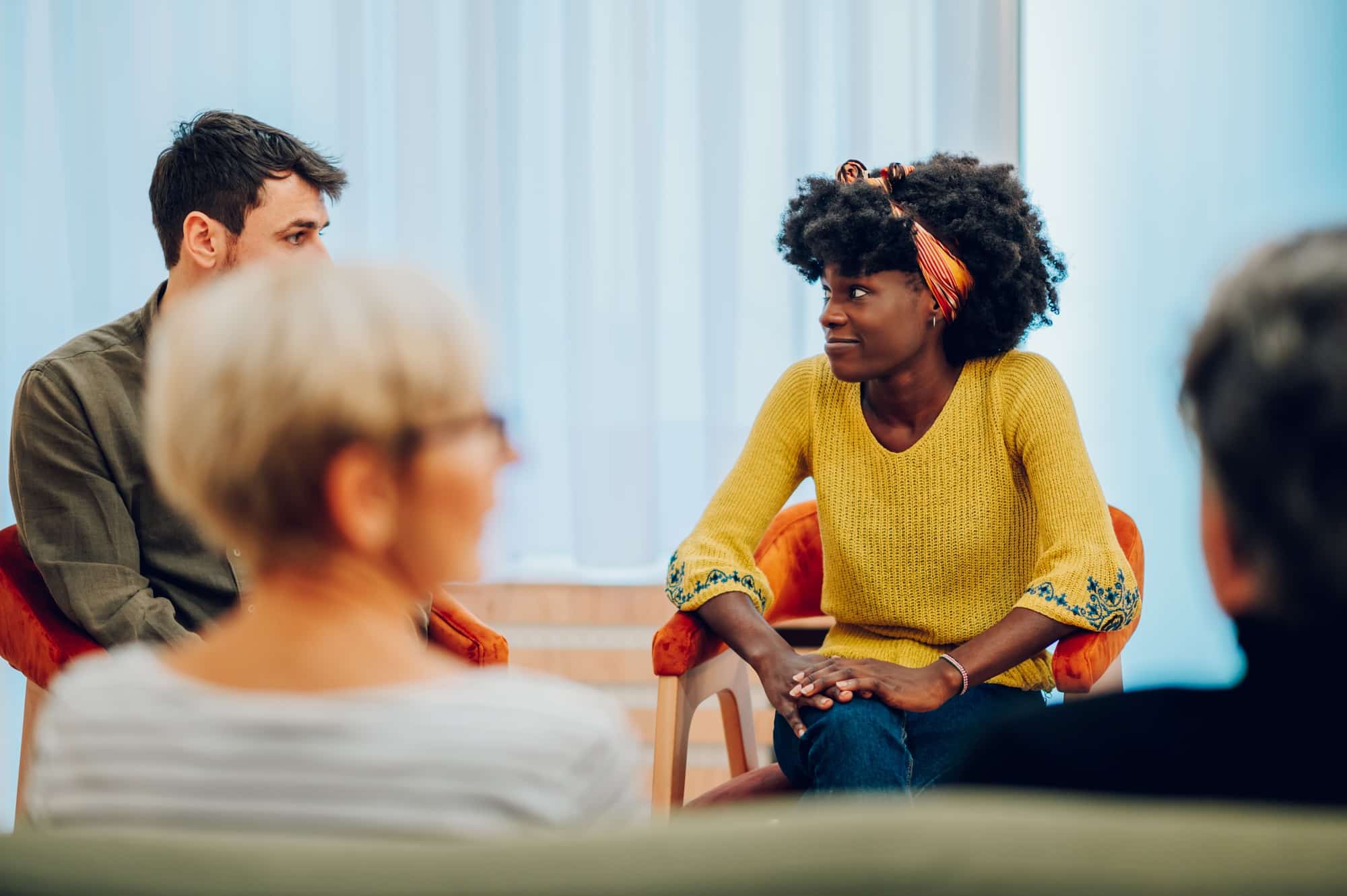 African american woman talking about her mental health on a group therapy session