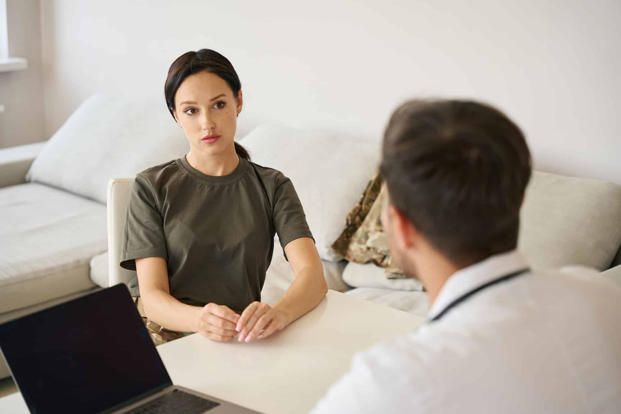 Military woman talking to doctor in hospital