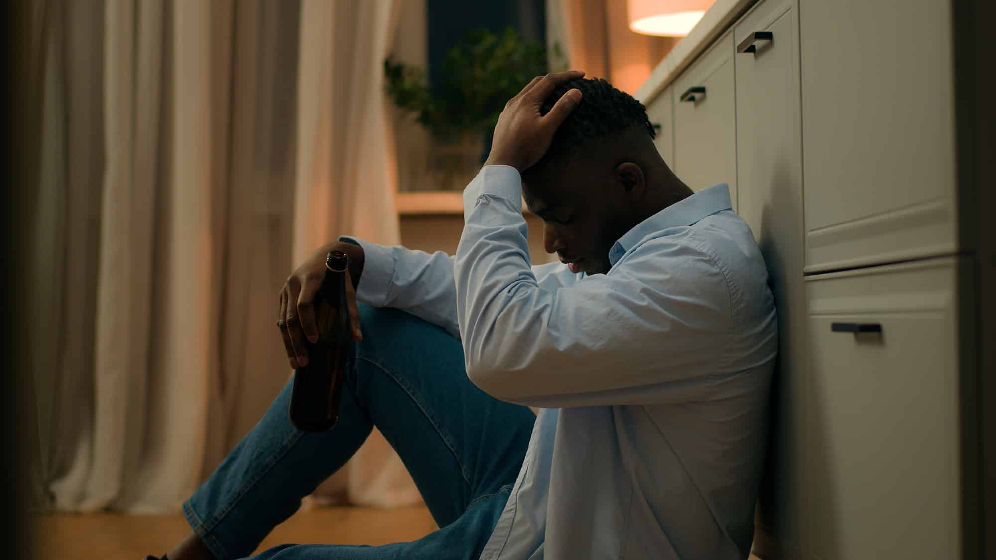 Stressed alcohol addicted drunk African American male stress problem trouble addict depressed